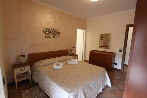 a bedroom with a bed with two bags on it at Casa Nicole in Manerba del Garda