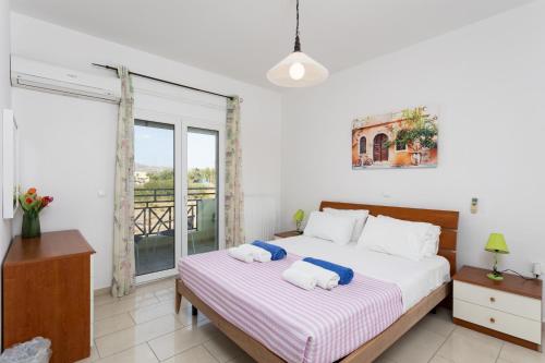 a bedroom with a bed and a large window at Amphitrite Villa in Gennadi