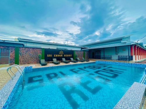 a swimming pool in front of a building at Sri Embun Resort Langkawi in Pantai Cenang