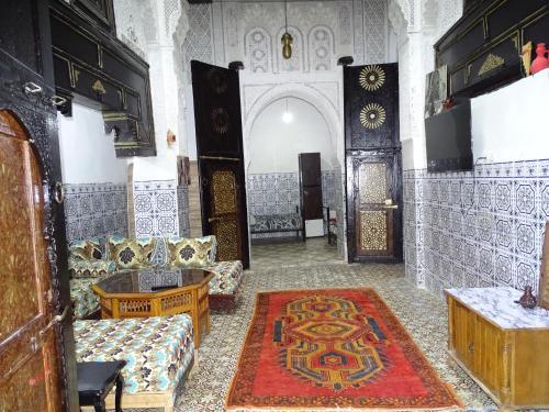 a living room with two couches and a rug at Riad Amimi Fes in Fez