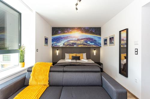 a bedroom with a bed with a yellow blanket at R73 Residences in Pécs