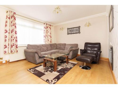 a living room with a couch and a chair at Alexander House Apartments in Leeds