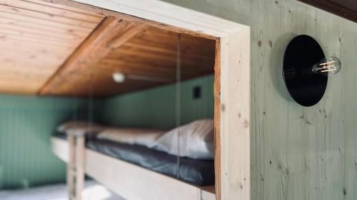a bird house with a bed in a room at Hotel Alpina Einhorn - Self-Check-In in Wolfenschiessen