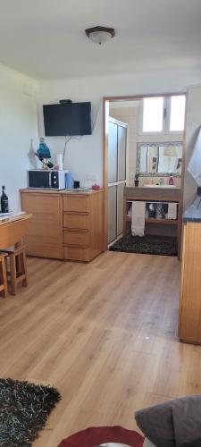 a large kitchen with wooden floors and a refrigerator at SUNSET REFUGE in Fajã da Ovelha