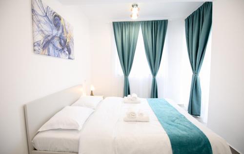 a bedroom with a white bed with green curtains at Vitan Central Oasis - NEW Building - FREE Secured Private PARKING - Self Check-in - in Bucharest