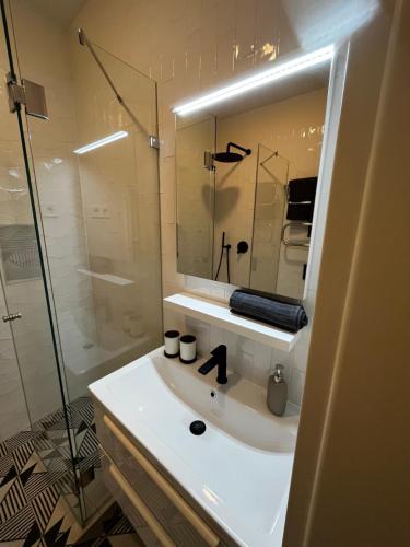 a bathroom with a white sink and a shower at A96 in Budapest