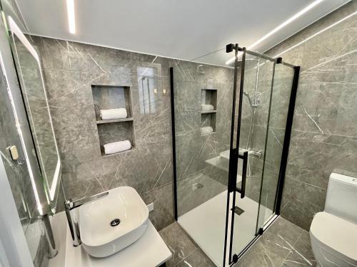ein Bad mit einer Dusche, einem WC und einem Waschbecken in der Unterkunft Trendy Loft Apartment in Limassol