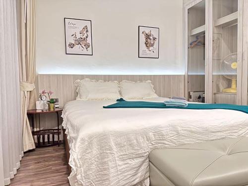 a bedroom with a large white bed in it at OCEANA HOME Phuket Kamala in Kamala Beach