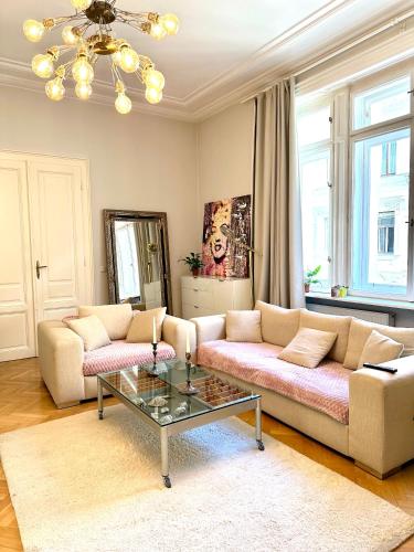 a living room with two couches and a coffee table at Stephansdom apartment in Vienna