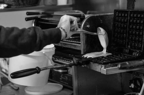 a person is putting a utensil in a machine at Hotel Spa L'Equipe in Molines-en-Queyras