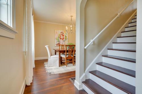a hallway with stairs and a dining room with a table at Cozy Zanesville Home about 9 Mi to Dillon State Park! in Zanesville