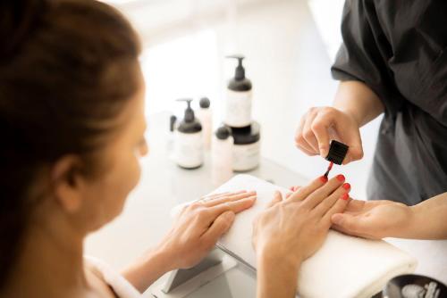 a woman getting her nails done in a salon at President Hotel, Valamar Collection in Dubrovnik