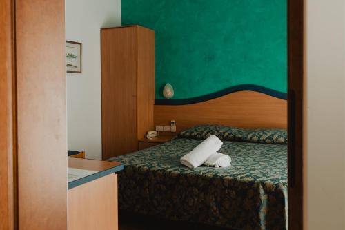 a hotel room with a bed with two towels on it at Hotel Bellavista in Grado