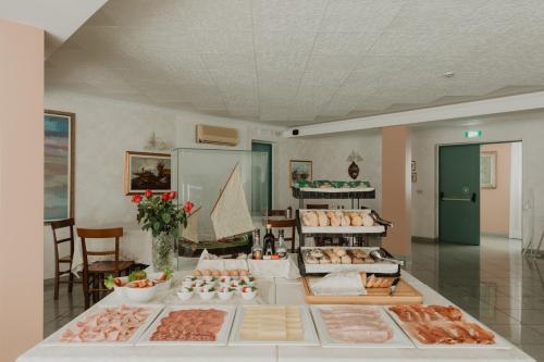 a buffet of meats and pastries on a table at Hotel Bellavista in Grado