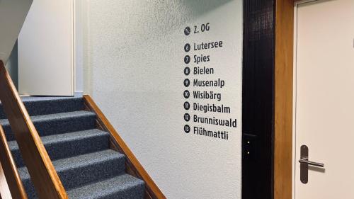 a stairway with a wall with words on it at Hotel Alpina Einhorn - Self-Check-In in Wolfenschiessen