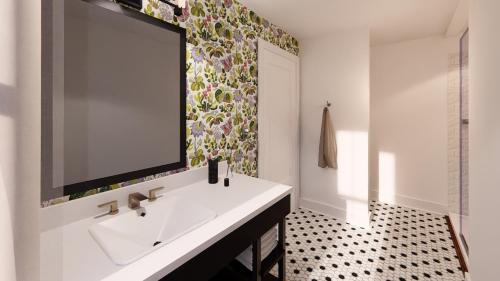 a bathroom with a sink and a large mirror at The Painted Lady in Birmingham