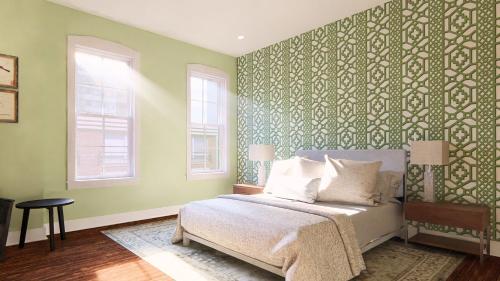 a bedroom with a bed and a green wall at The Painted Lady in Birmingham