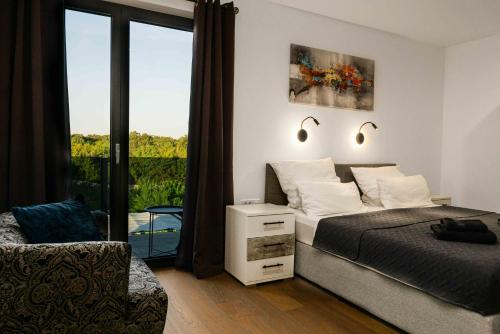 a bedroom with a bed and a window with a view at Villa More in Krk