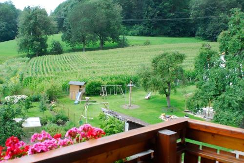 a view of a garden from a balcony with flowers at Mayer Burghöfe in Owingen