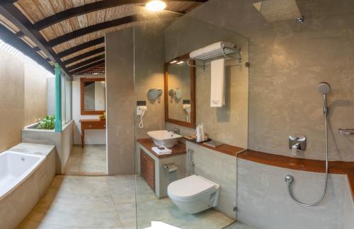a bathroom with a toilet and a sink and a tub at Villa V Kalutara in Wadduwa