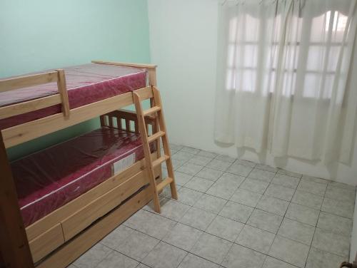 a room with a bunk bed and a window at CASA CON COCHERA, HASTA 7 PERSONAS in Las Heras