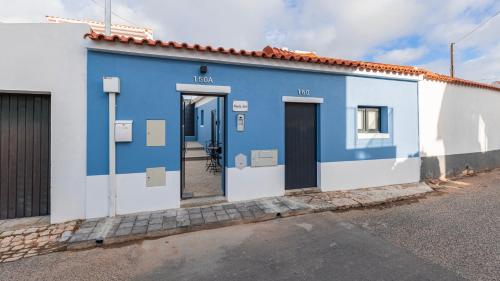 a blue and white building with two doors at Noah's Ark by LovelyStay in Cascais