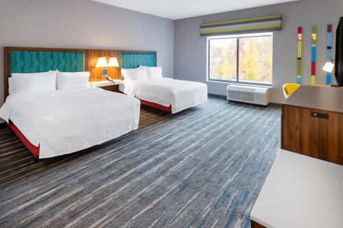 a hotel room with two beds and a window at Hampton Inn Monticello, Ny in Monticello
