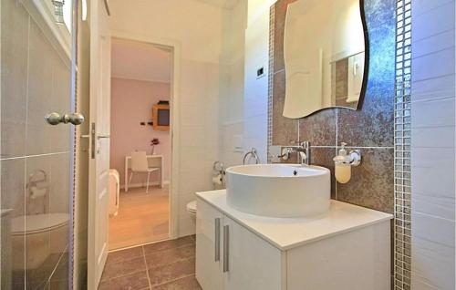 a white bathroom with a sink and a mirror at Villa Inga in Buje