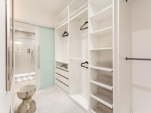 a white bathroom with a walk in closet at Spire View in Aberdeen