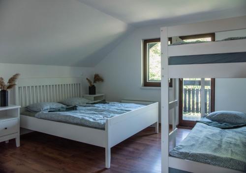 a bedroom with two beds and a bunk bed at HOSTEL VANEČA in Puconci
