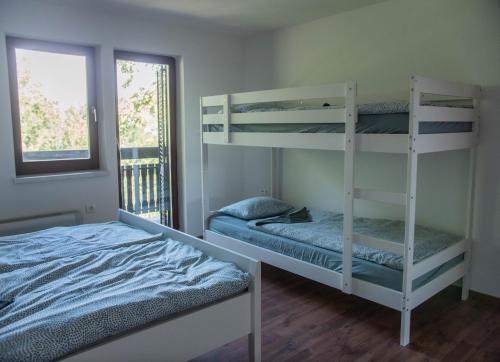 a bedroom with two bunk beds and a bed at HOSTEL VANEČA in Puconci