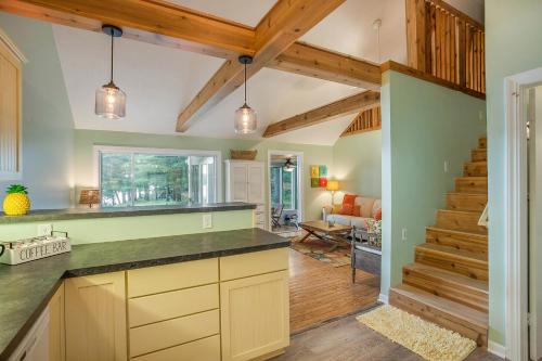a kitchen with a counter top and a living room at Waterfront Newaygo Cottage with Private Dock and Beach in Newaygo