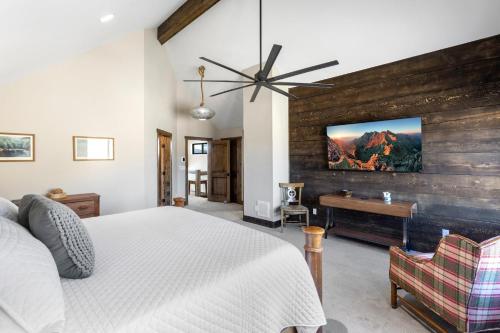 a bedroom with a bed and a wooden wall at Rocking M Ranch in South Fork, CO in South Fork