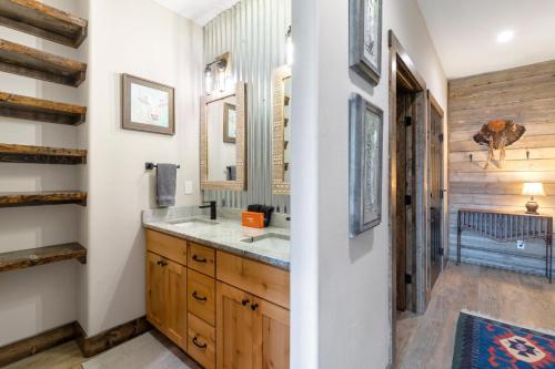 a bathroom with a sink and a mirror at Rocking M Ranch in South Fork, CO in South Fork