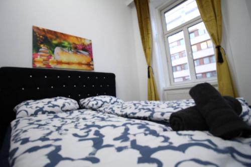 a bedroom with a bed with a comforter and a window at Modern Double room JS in Vienna
