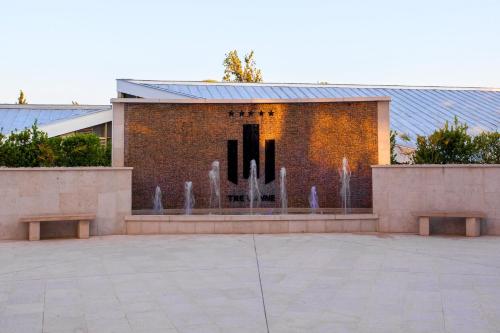 a building with a fountain in front of it at Luxury Apartment Anastasia Tre canne in Budva