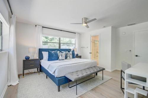 een slaapkamer met een blauw bed en een raam bij Paradise Palms House in Delray Beach