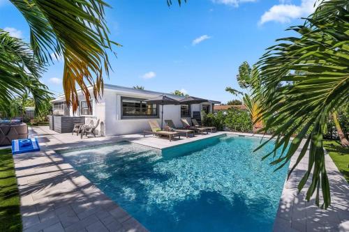 a swimming pool in a yard with a house at Paradise Palms House in Delray Beach