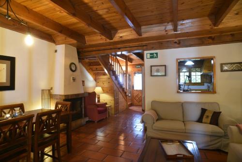 a living room with a couch and a fireplace at La Casita de la Sierra Cercedilla in Cercedilla