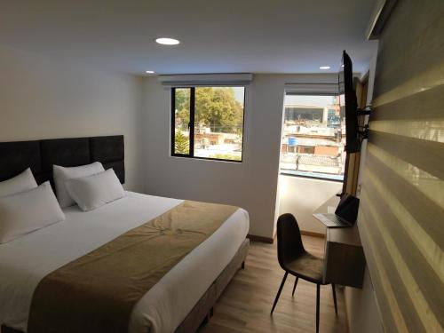 Postel nebo postele na pokoji v ubytování HOTEL MX BOGOTA