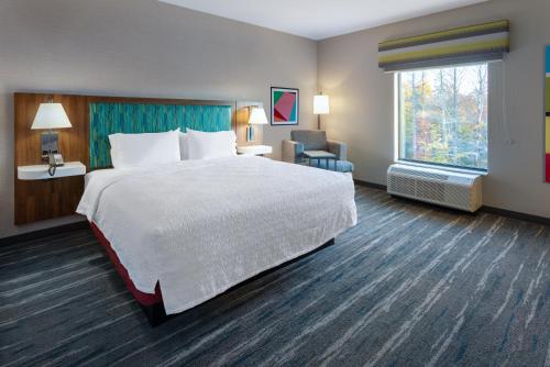 a hotel room with a large bed and a window at Hampton Inn Monticello, Ny in Monticello