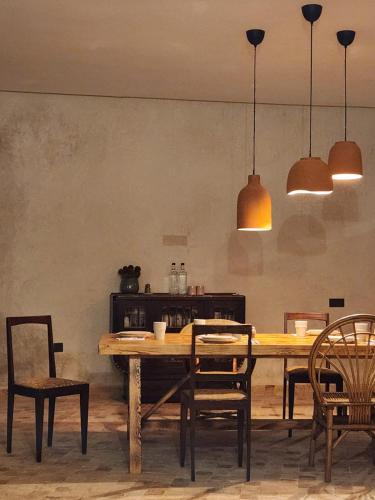 a dining room with a wooden table and chairs at Loued Surf Lodge in Imsouane