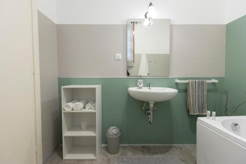 a bathroom with a sink and a mirror at My Sicily Home - Casa con giardino in Salemi