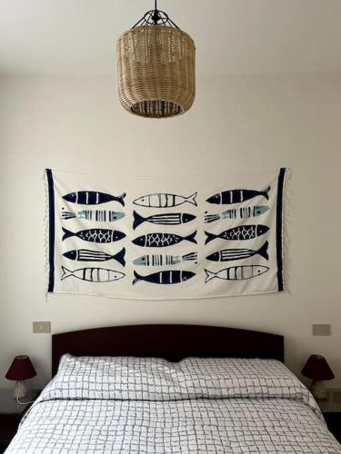 a bedroom with a bed with black and white pillows at Ca' Nildes in Clusane sul Lago