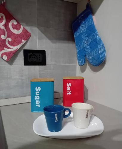 three coffee cups on a plate on a counter at Villa Nonno Nicola in Montenero di Bisaccia