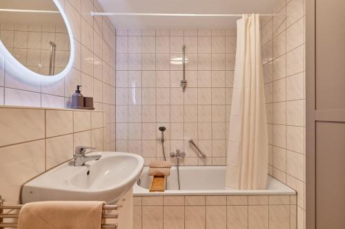 a bathroom with a sink and a bath tub at NEW-Emma - Glashofen Walldürn in Walldürn