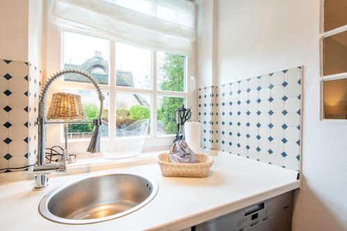 a kitchen with a sink and a window at Haus Alster Whg 1 in Keitum