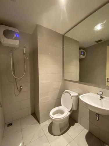 a bathroom with a toilet and a sink at Luxury 2BR Benson Apartment, Pakuwon Mall in Surabaya