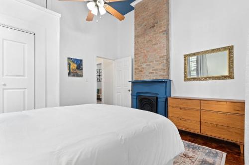 a bedroom with a bed and a fireplace at Bywater Bungalow in New Orleans