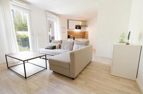 a living room with a couch and a table at Pascal’s Cosy Retreat in Rosny-sous-Bois
